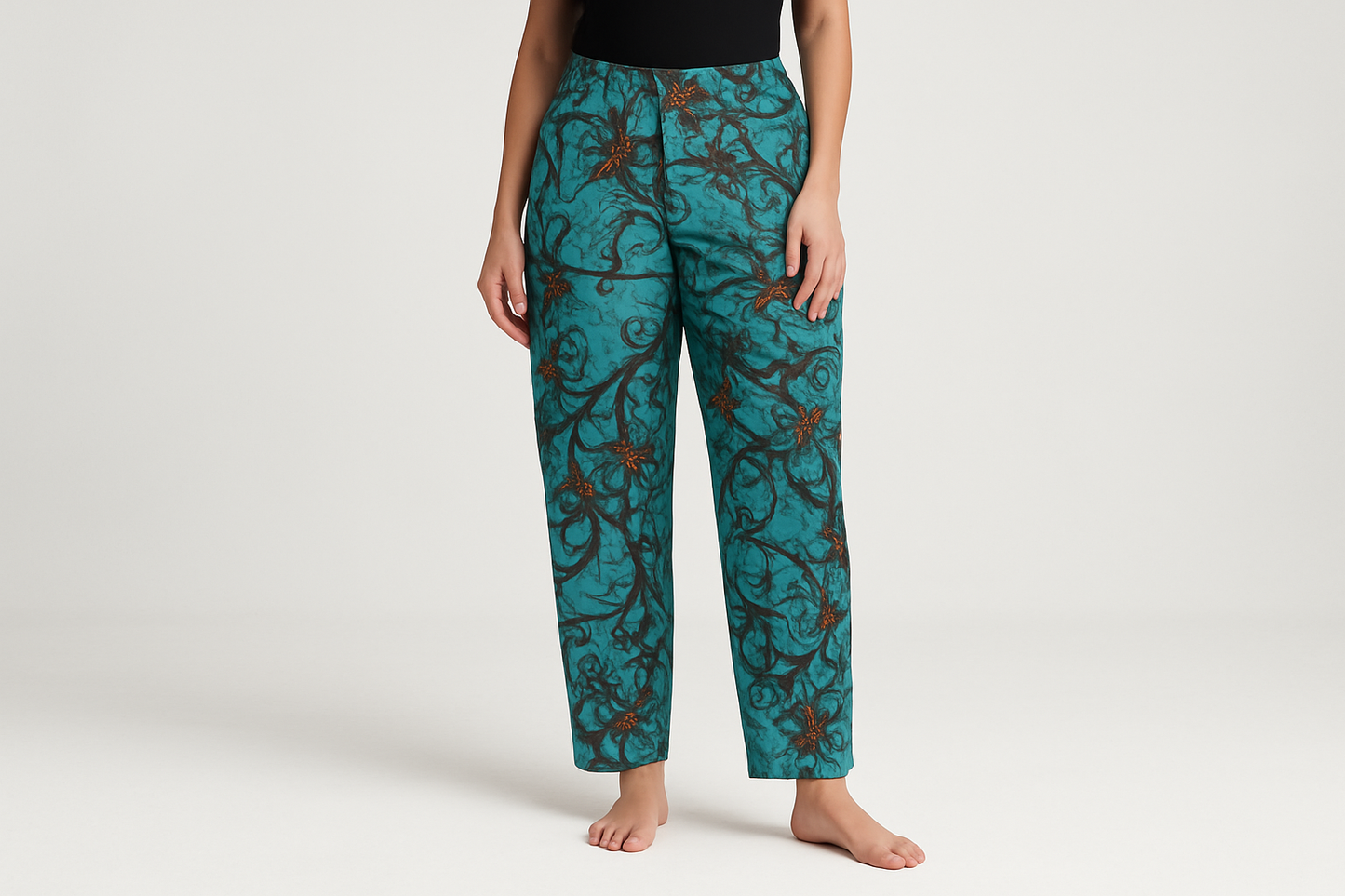 Model wearing teal patterned pants - waist down view